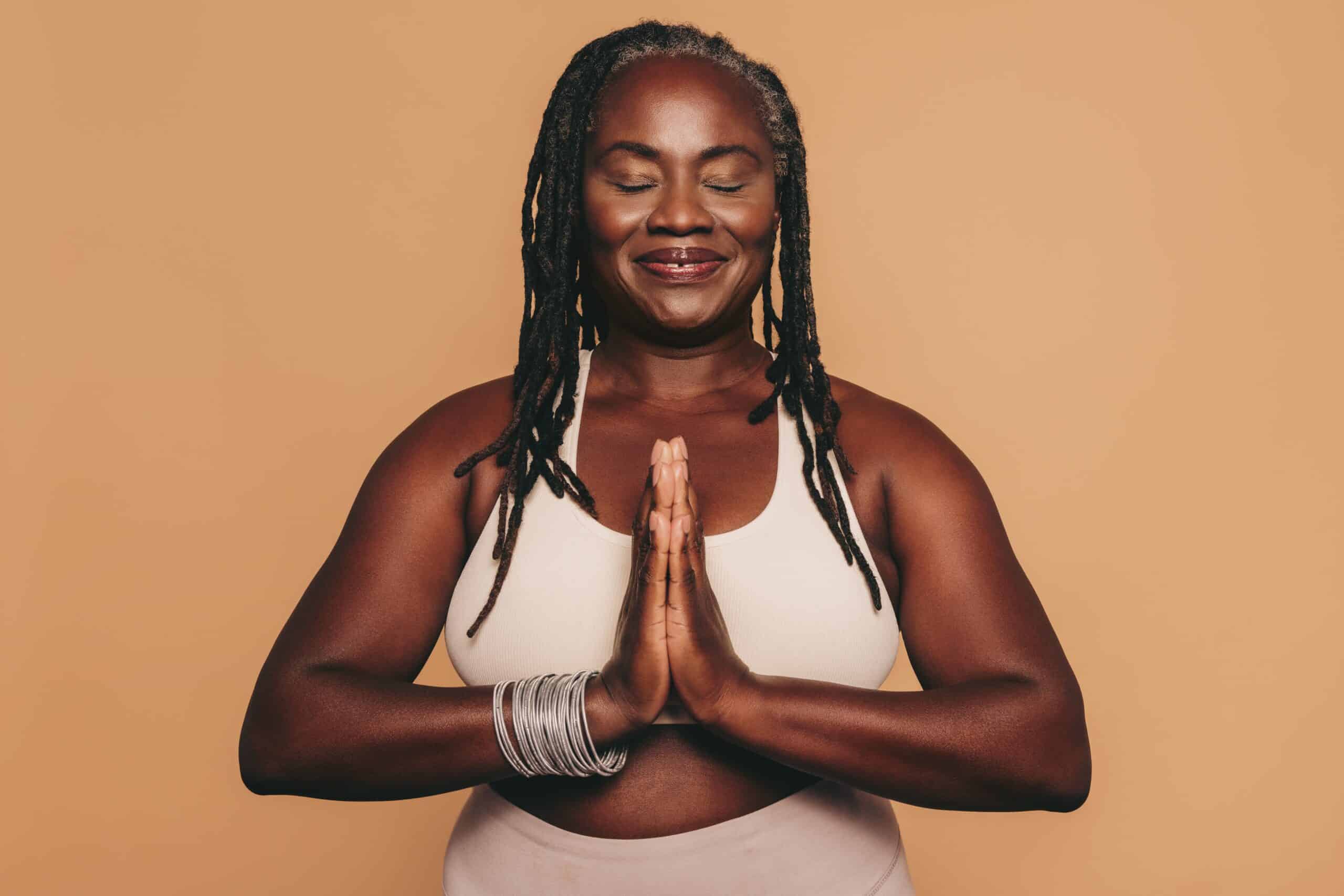 Mature,Woman,Meditating,With,Her,Eyes,Closed,And,Her,Hands
